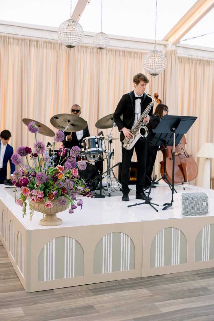 Saxophonist and jazz band on decorated stage